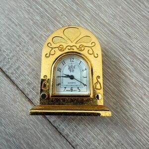 Gold metal desk clock with fleur de lis design timex